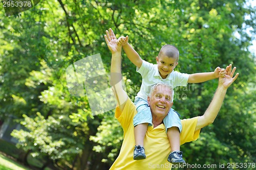 Image of happy grandfather and child in park