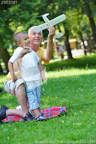 Image of happy grandfather and child in park