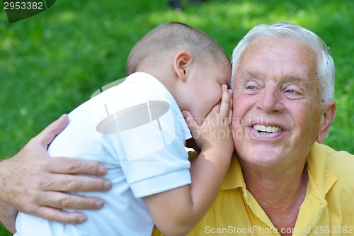 Image of happy grandfather and child in park