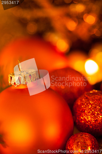 Image of Warm gold and red Christmas candlelight background