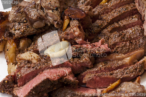 Image of Plate of Grilled Steak and Garlic with Red Napkin