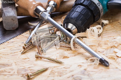 Image of Drill with timber, screwdrivers and screws