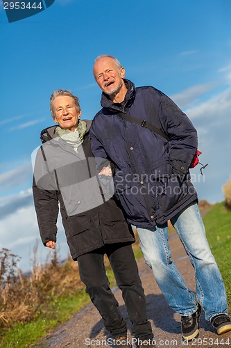 Image of happy mature couple relaxing baltic sea dunes 