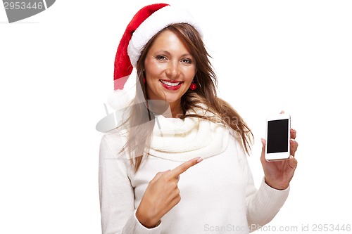 Image of Pretty woman in a Santa hat reading an sms