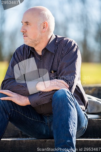 Image of Thoughtful man sitting on a flight of steps