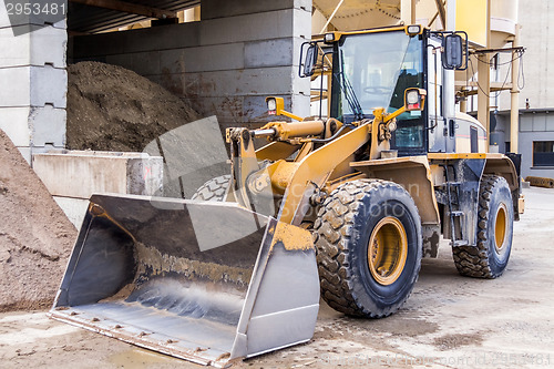 Image of Parked pay loader near pile of dirt