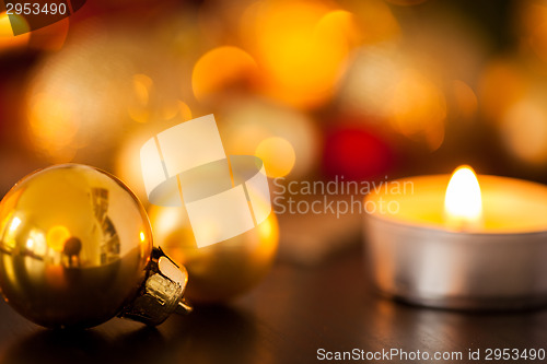 Image of Warm gold and red Christmas candlelight background