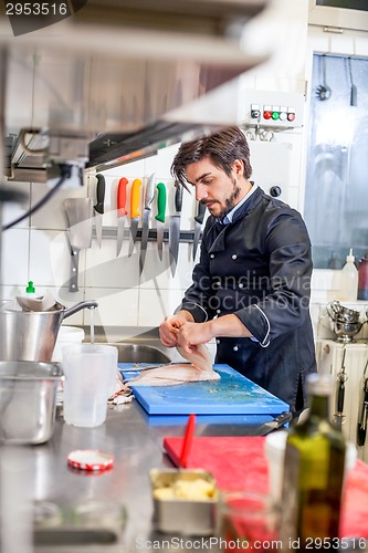 Image of Chef cooking a vegetables stir fry over a hob