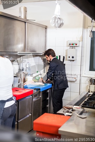 Image of Chef cooking a vegetables stir fry over a hob