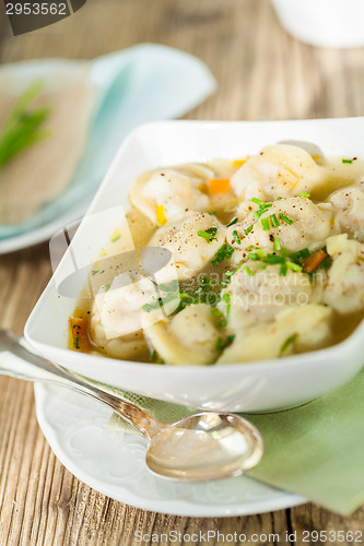 Image of Dish of savory pork tortellini in broth pelmeni russian