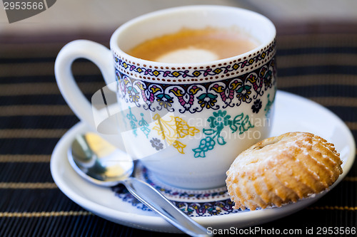 Image of Cup of freshly brewed tea and a cookie
