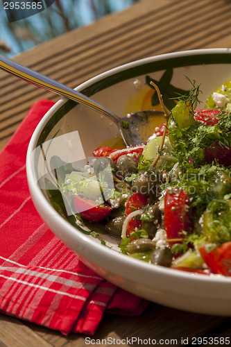 Image of Bowl of Marinated Greek Salad with Red Napkin