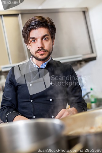 Image of Chef cooking a vegetables stir fry over a hob