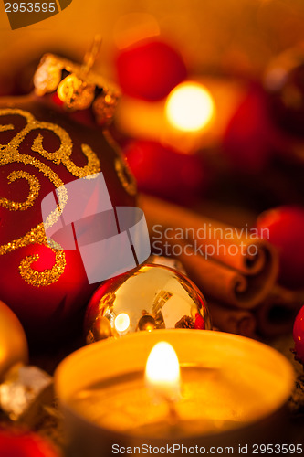 Image of Warm gold and red Christmas candlelight background