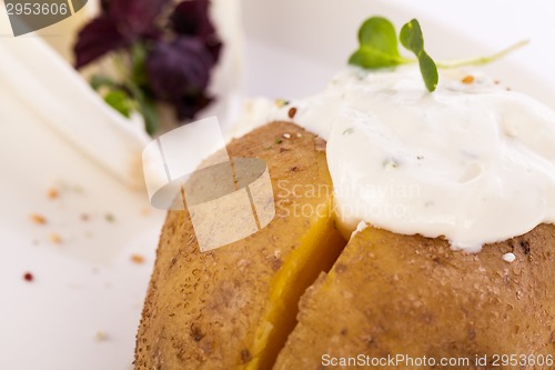 Image of Baked jacket potato with sour cream sauce