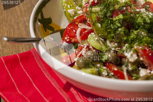 Image of Bowl of Marinated Greek Salad with Red Napkin