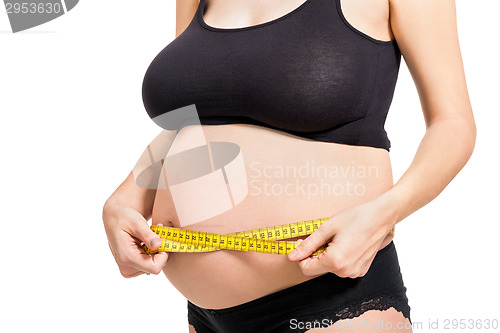 Image of Pregnant woman measuring her abdomen