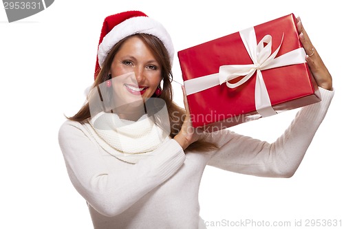 Image of Pretty woman in a Santa hat with a large gift