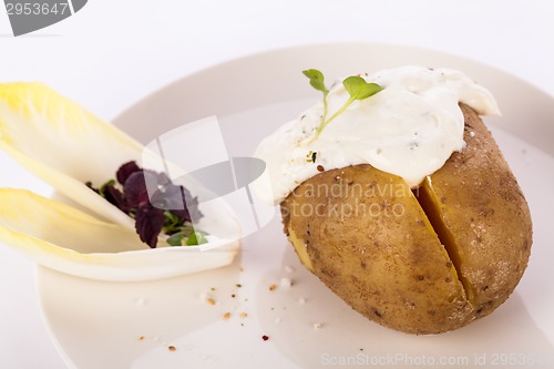 Image of Baked jacket potato with sour cream sauce