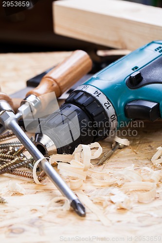 Image of Drill with timber, screwdrivers and screws