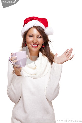 Image of Cold young woman in a Santa hat sipping coffee tea