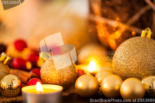 Image of Warm gold and red Christmas candlelight background