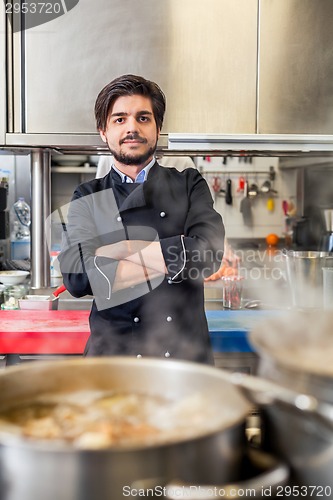 Image of Chef cooking a vegetables stir fry over a hob