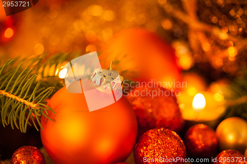 Image of Warm gold and red Christmas candlelight background