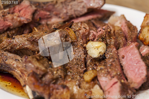 Image of Plate of Grilled Steak and Garlic with Red Napkin