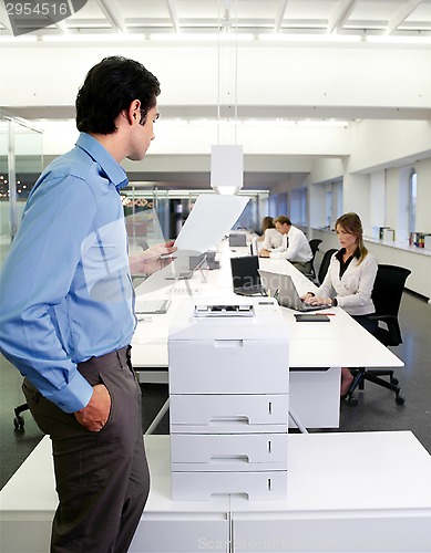 Image of worker with copy machine in office
