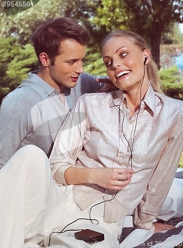 Image of couple listening music in square