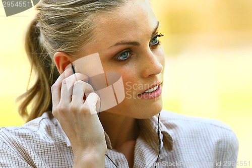 Image of face of beautiful woman listening music