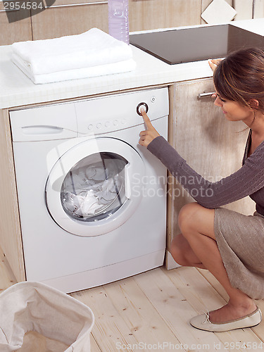 Image of pretty smiling girl in the laundry room lhn