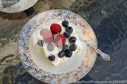 Image of Piece of gateau with raspberry and blueberry