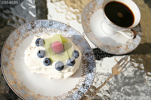 Image of Piece of gateau with kiwi, raspberry and blueberry