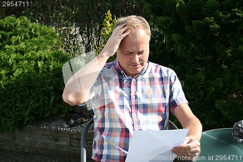 Image of Swedish man is reading letter