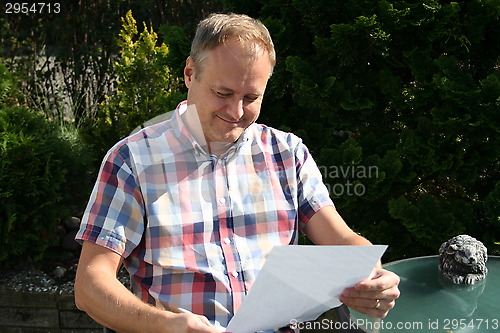 Image of Swedish man is reading letter