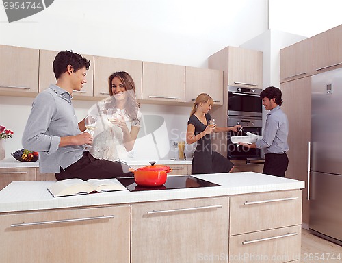 Image of friends preparing pasta and cooking spaghetti