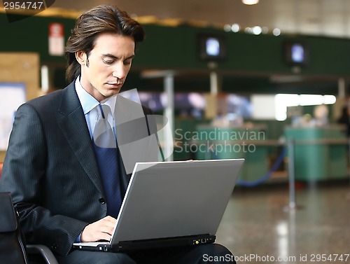 Image of businessman sitting in the airport b