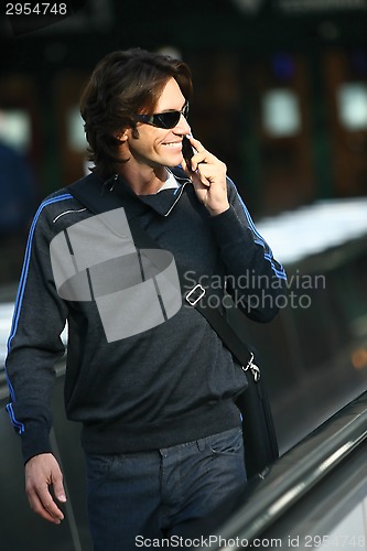 Image of businessman walking in airport ji