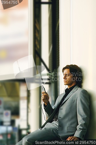 Image of Man listening to music a