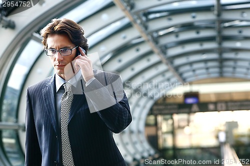 Image of talking on mobile phone in airport
