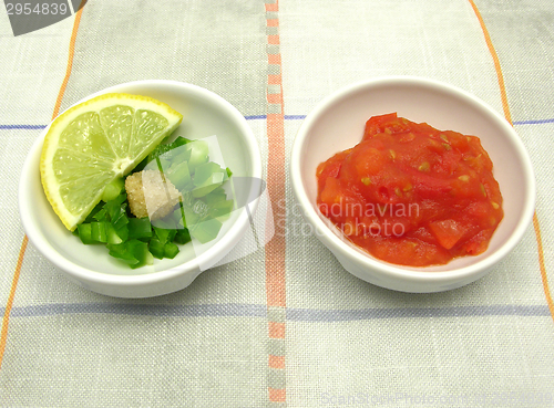 Image of Little bowls of chinaware with tomatodip and green pepperdip