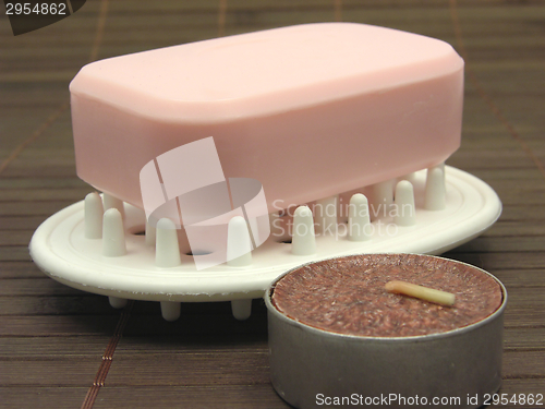 Image of Pink soap with tea light on a  brown background