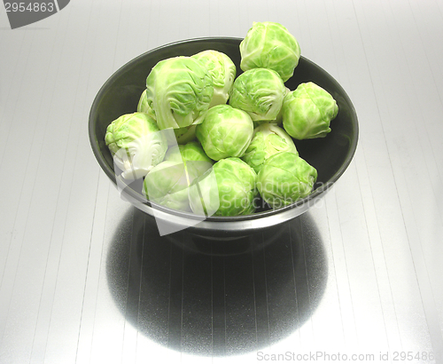 Image of Bowl of chinaware with brussels sprouts on reflecting matting