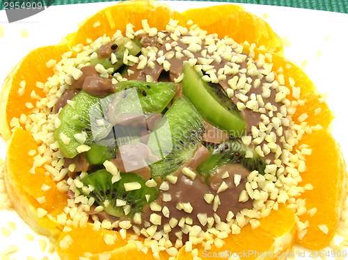 Image of Chocolate pudding with kiwi fruit, orange and little pieces of a