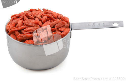 Image of Red goji berries in a cup measure