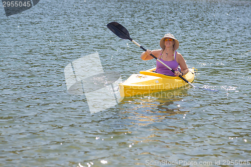 Image of Woman Kayaking on Beautiful Mountain Lake.