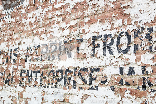 Image of Old Weathered Brick Wall with Advertisement