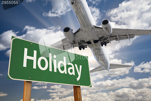 Image of Holiday Green Road Sign and Airplane Above